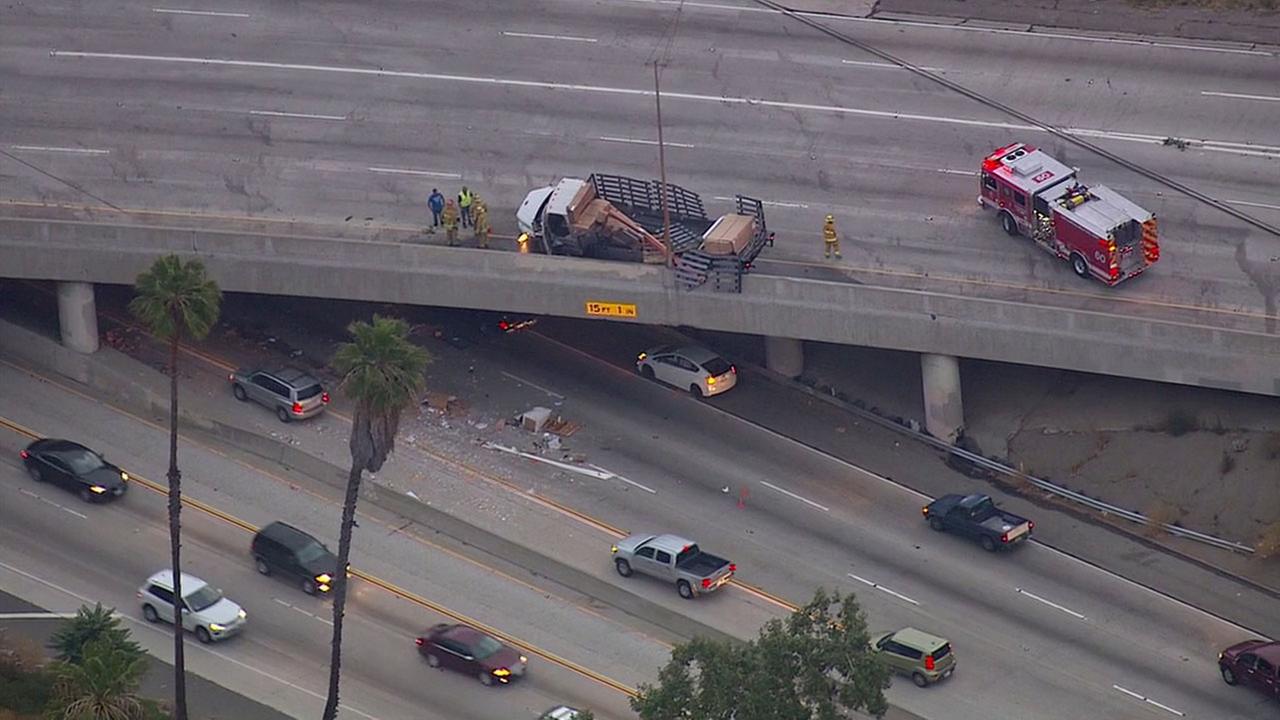 Debris from truck crash on overpass causes delays on multiple freeways
