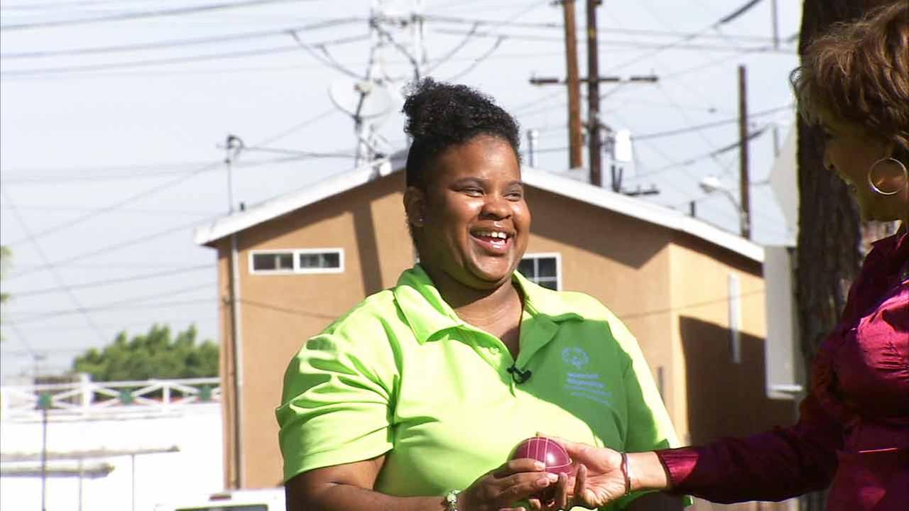 Special Olympics athlete teaches Leslie Sykes bocce ball