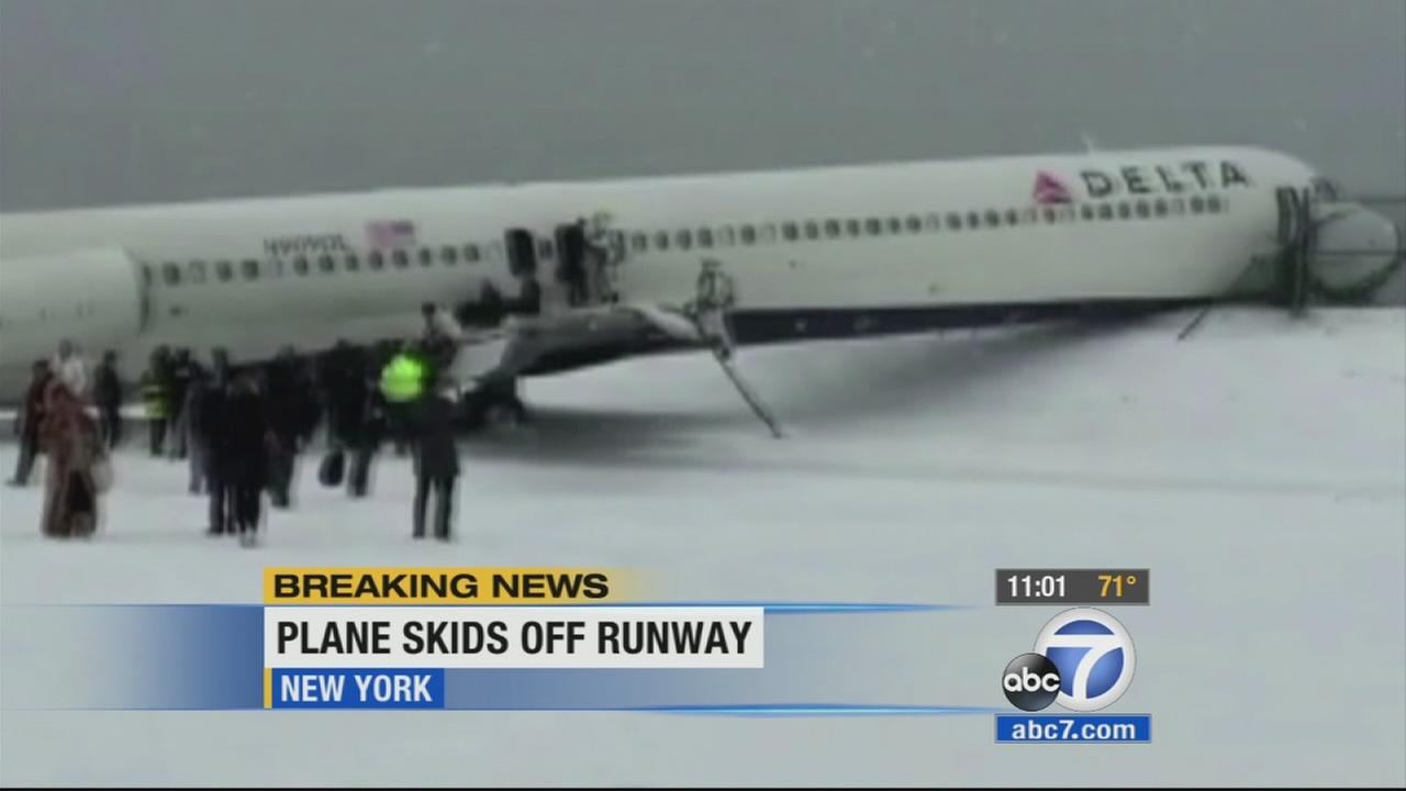 Plane skids off runway at LaGuardia airport, crashes into fence