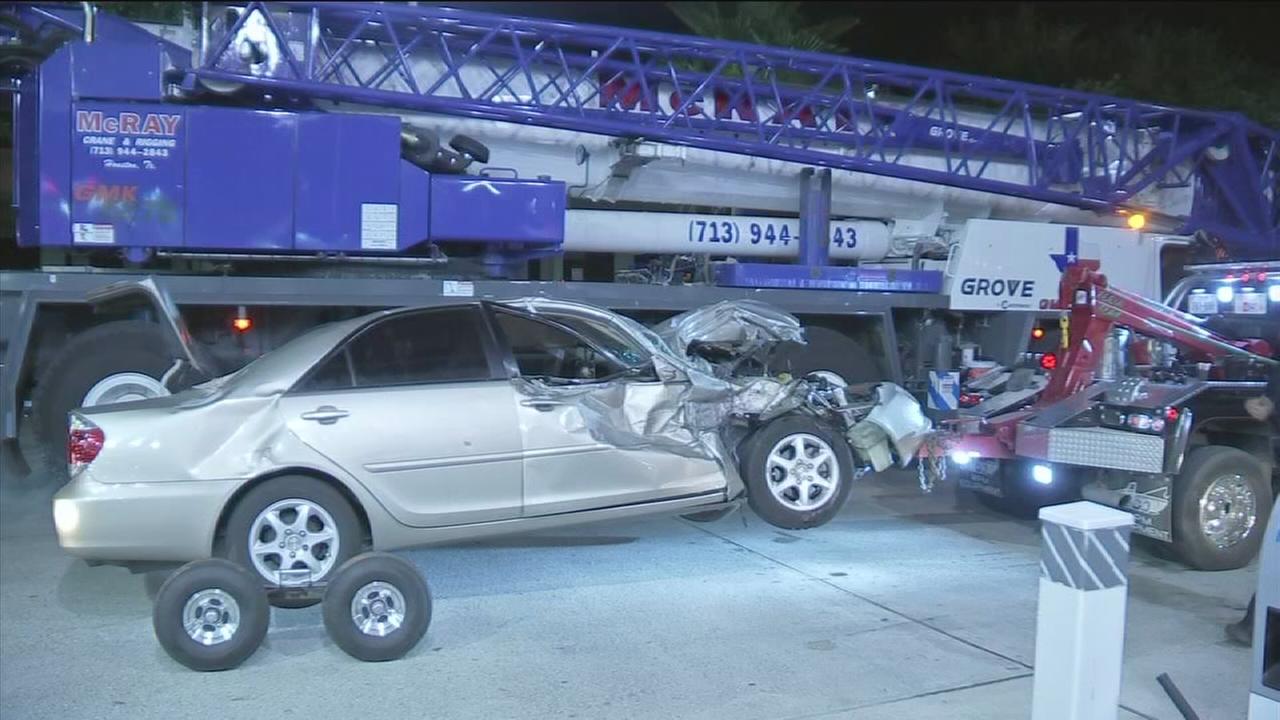 Car badly damaged after accident with crane
