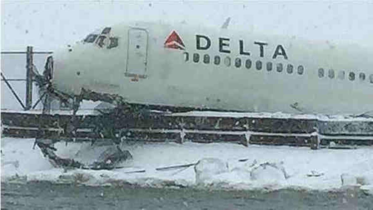 Plane skids off runway at LaGuardia airport, crashes into fence